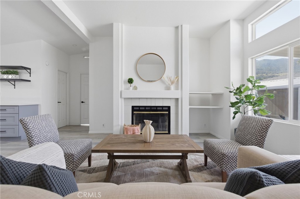 4901 Green River Road, Unit 153 Corona, CA 92878 - Photo 8 of 55 a living room with furniture and a fireplace
