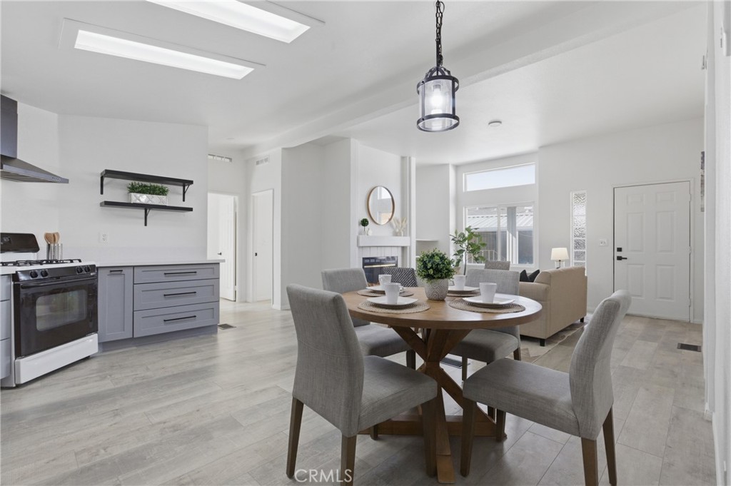 4901 Green River Road, Unit 153 Corona, CA 92878 - Photo 10 of 55 a view of a dining room with furniture and wooden floor