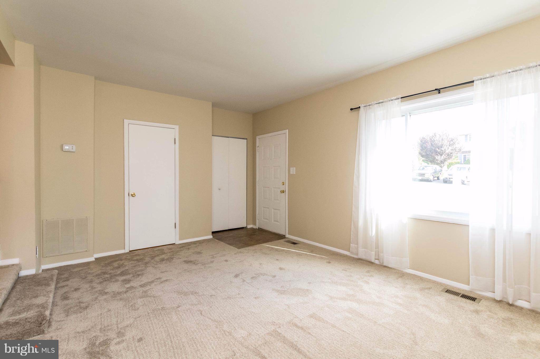 Sunny Living Room with Coat Closet