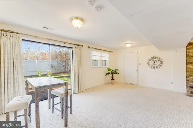 a view of a livingroom with a chair and dining table chair