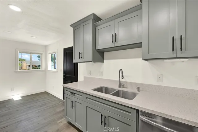a kitchen with stainless steel appliances white cabinets and a sink
