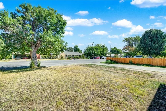 a view of yard with swimming pool and trees