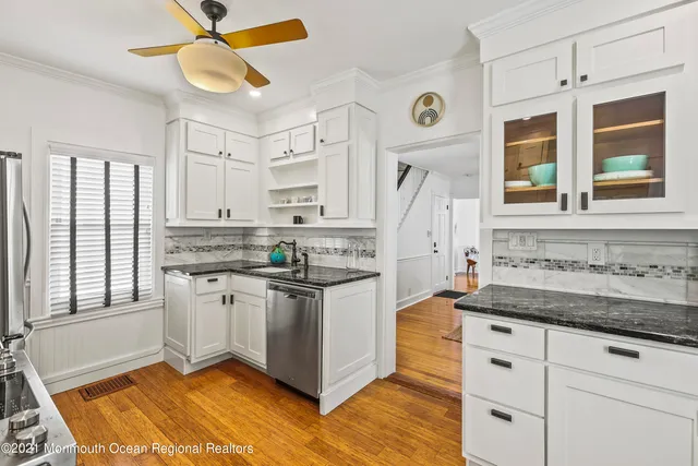 a kitchen with stainless steel appliances granite countertop a stove and a sink