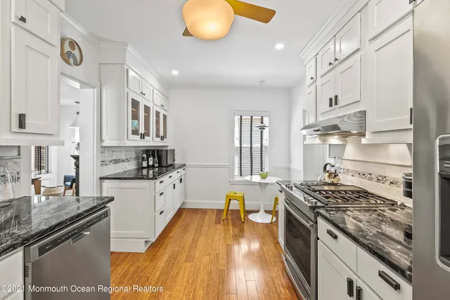 a kitchen with stainless steel appliances granite countertop a stove and a sink