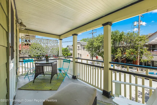 a view of a porch with furniture and garden