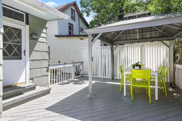 a view of deck with table and chairs with wooden floor and fence