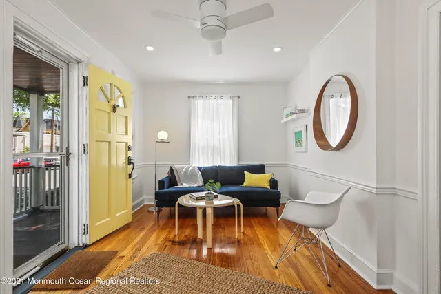 a living room with furniture a rug and a window