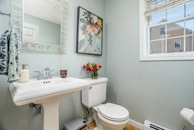 a bathroom with a sink mirror and toilet