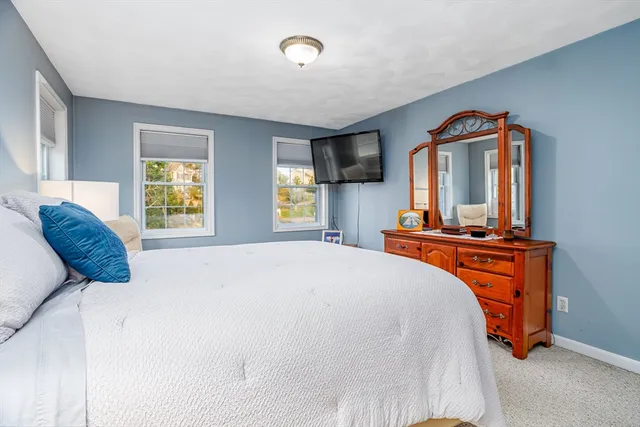 a bedroom with a large bed and a large window