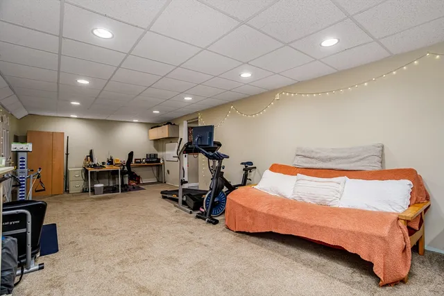 a bedroom with furniture and a gym equipment