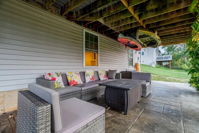 a view of a backyard with a table and chairs
