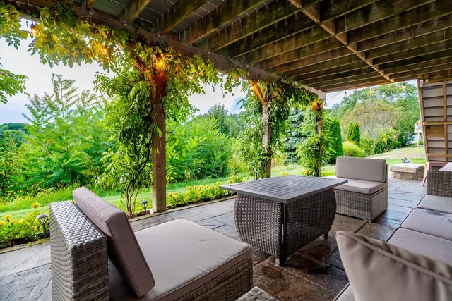 a view of a patio with table and chairs and potted plants