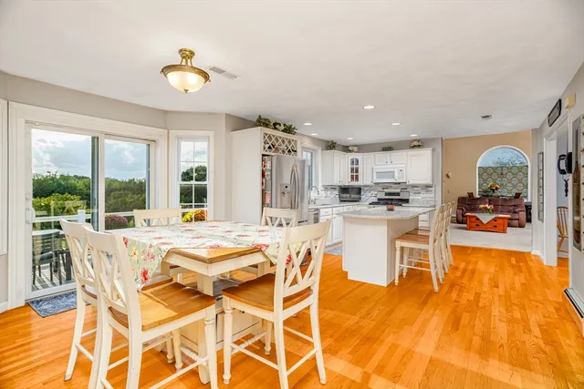 a view of a dining room with furniture and a kitchen