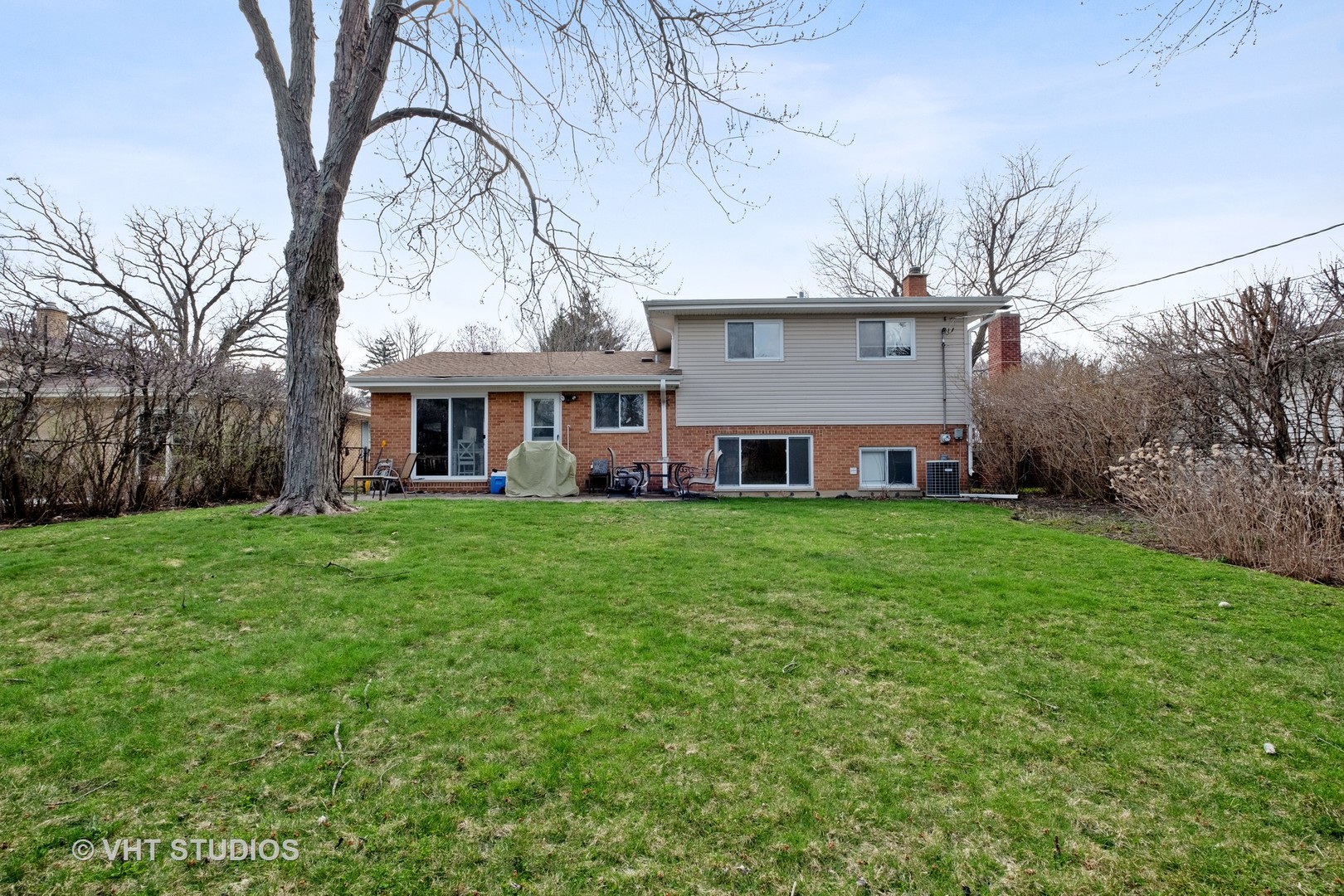 1021 Knollwood Road Deerfield, IL 60015 - Photo 17 of 20 a view of a house with a big yard and large trees