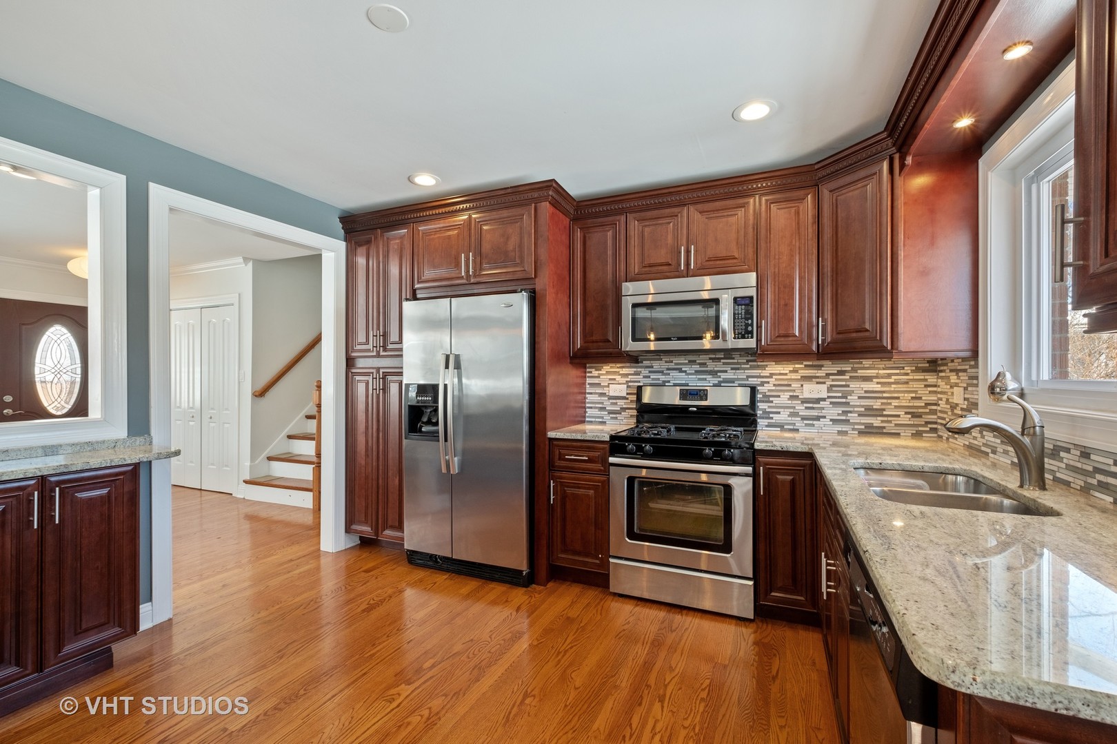1021 Knollwood Road Deerfield, IL 60015 - Photo 5 of 20 a kitchen with granite countertop a stove a sink and a microwave