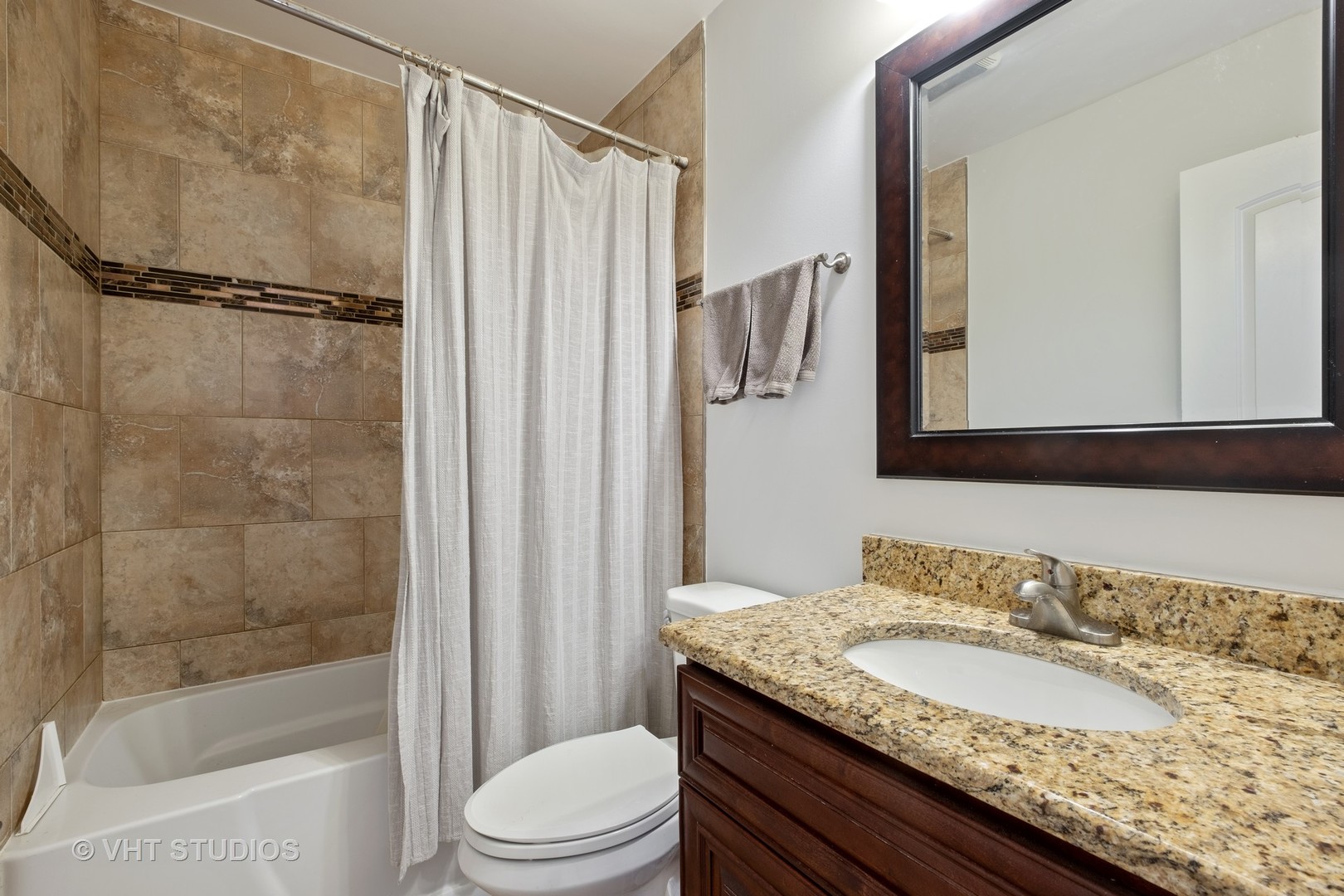 1021 Knollwood Road Deerfield, IL 60015 - Photo 9 of 20 a bathroom with a granite countertop sink toilet and shower