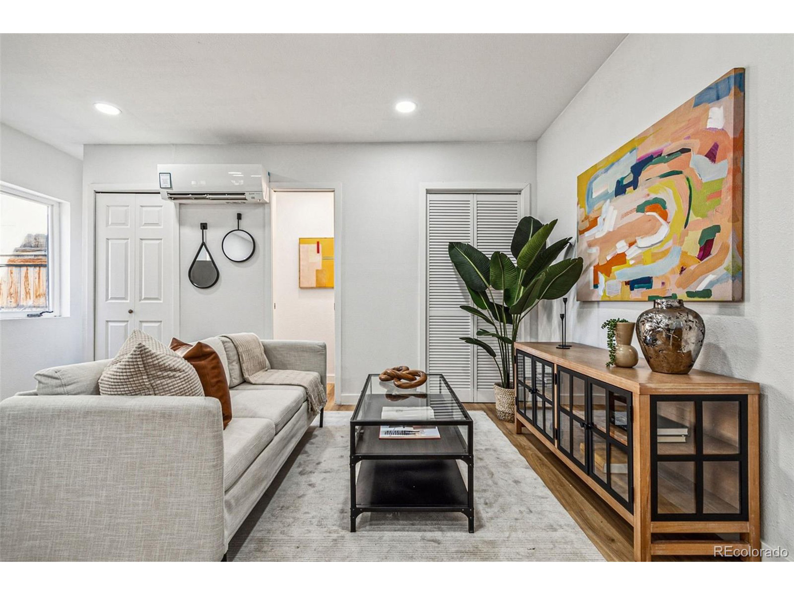 a living room with furniture and wooden floor