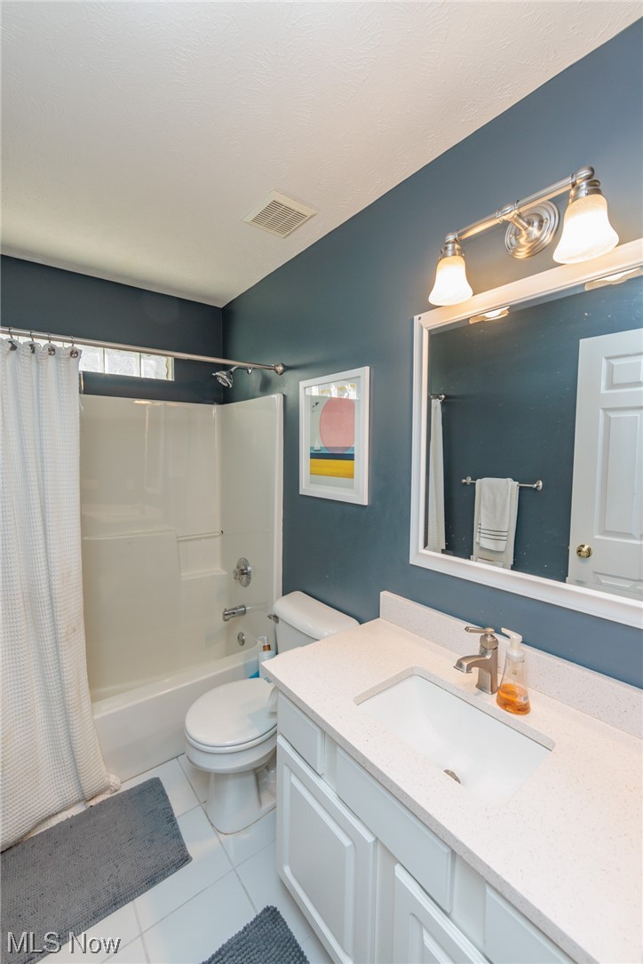 603 Literary Road Cleveland, OH 44113 - Photo 20 of 35 Full bathroom with toilet, oversized vanity, shower / tub combo, and tile flooring