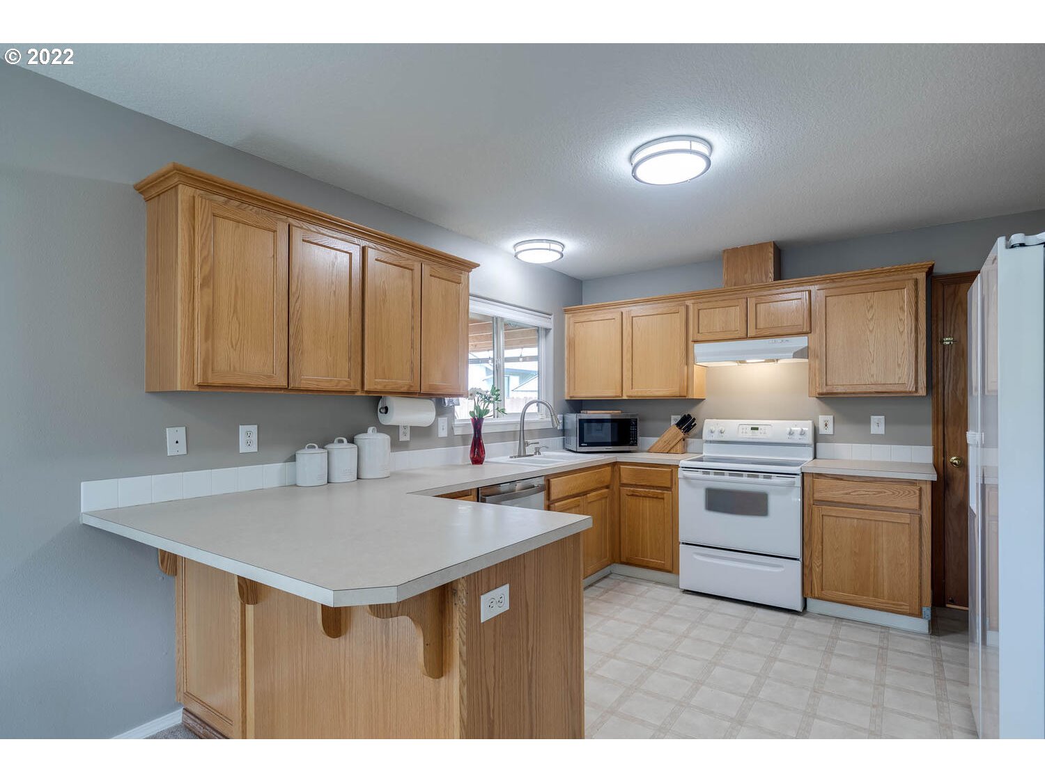 1013 Southwest Ivory Loop Gresham, OR 97080 - Photo 11 of 31 a kitchen with a sink stove and cabinets