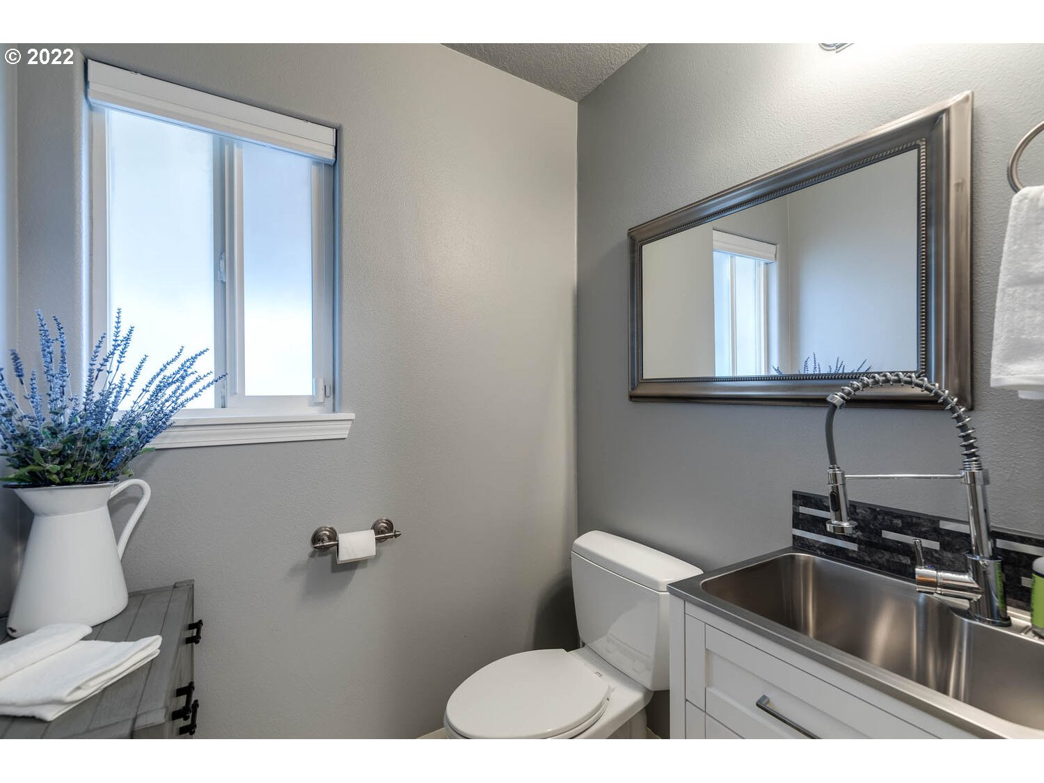 1013 Southwest Ivory Loop Gresham, OR 97080 - Photo 15 of 31 a bathroom with a toilet sink and mirror