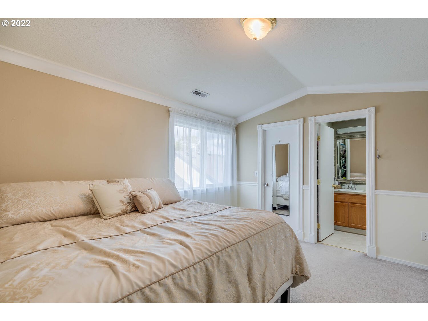 1013 Southwest Ivory Loop Gresham, OR 97080 - Photo 18 of 31 a bedroom with a large bed and a chandelier