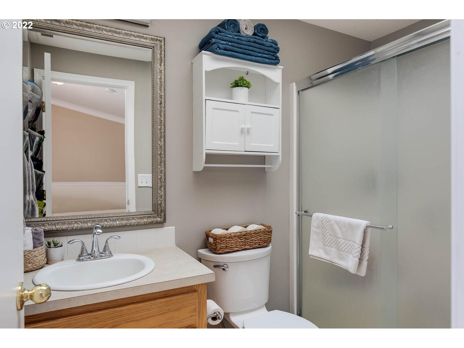 1013 Southwest Ivory Loop Gresham, OR 97080 - Photo 19 of 31 a bathroom with a toilet sink and mirror