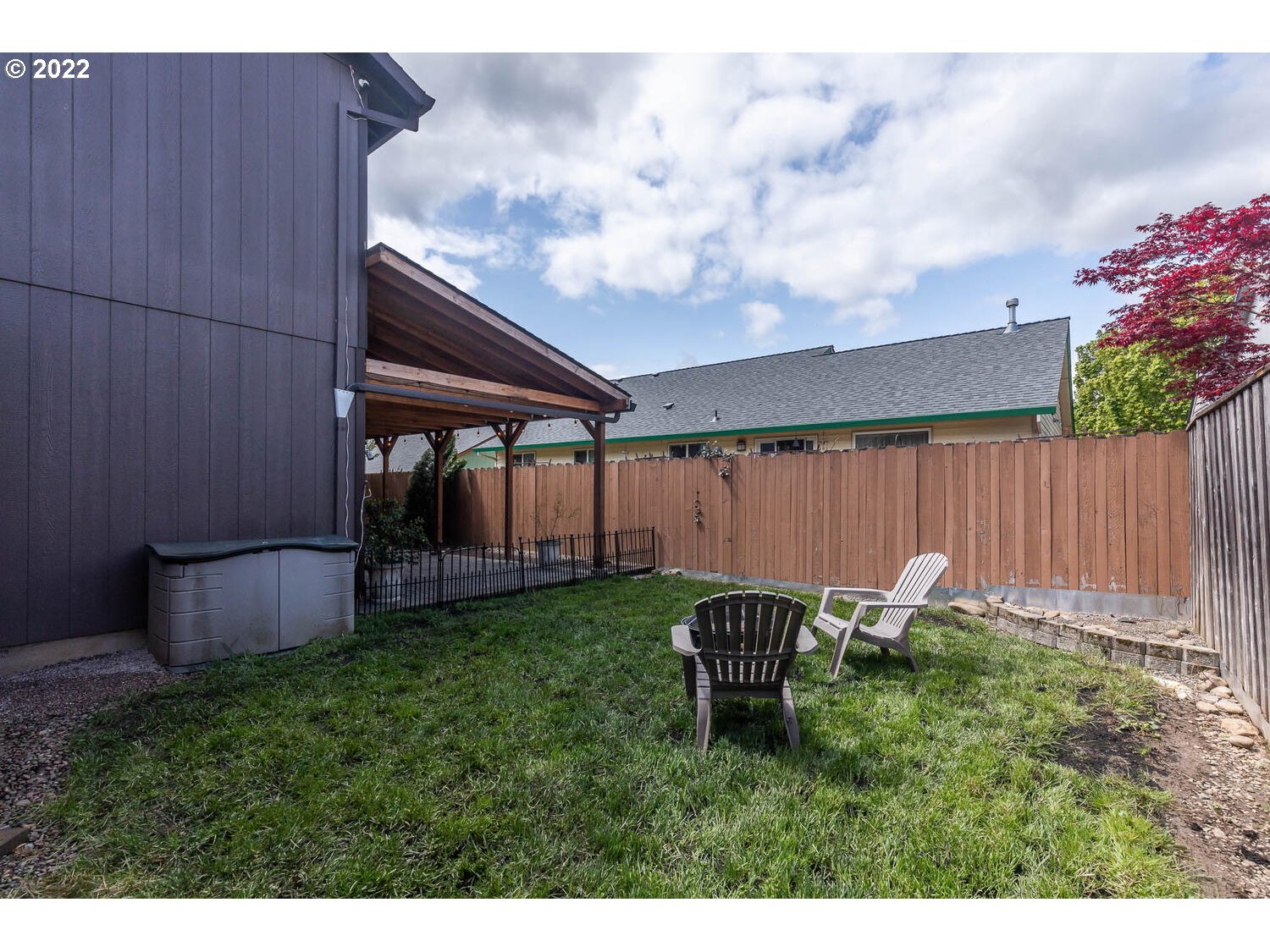 1013 Southwest Ivory Loop Gresham, OR 97080 - Photo 29 of 31 a backyard of a house with table and chairs