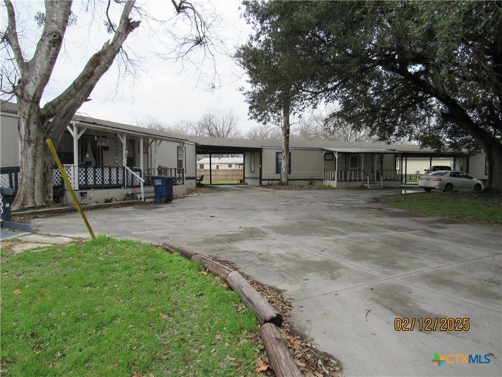 1650 Terminal Loop Road McQueeney, TX 78123 - Photo 2 of 5 a front view of a house with a yard and trees