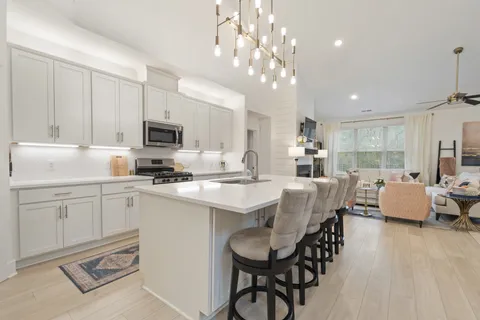 a kitchen with a sink stove and cabinets