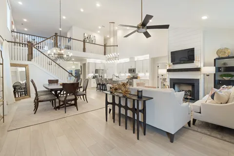 a living room with furniture kitchen view and a fireplace
