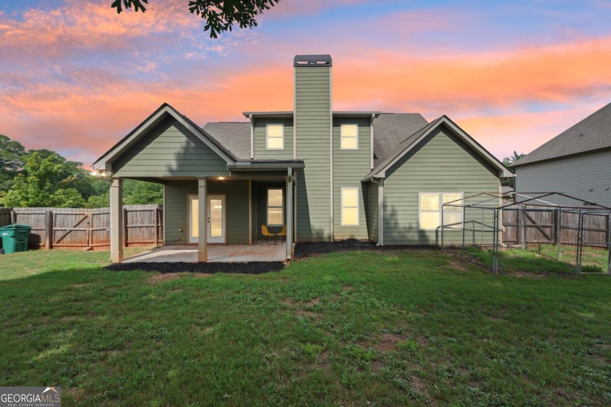 4007 Madison Acres Drive Locust Grove, GA 30248 - Photo 21 of 21 a front view of a house with a yard and porch
