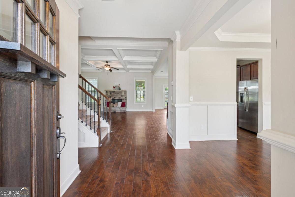 4007 Madison Acres Drive Locust Grove, GA 30248 - Photo 3 of 21 a view of a hallway with wooden floor and staircase