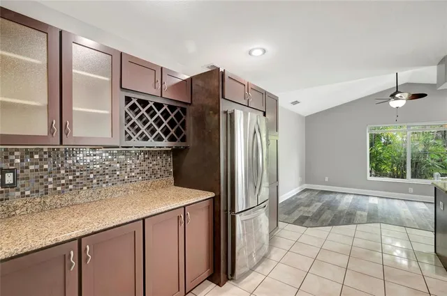 a kitchen with granite countertop a refrigerator and a sink