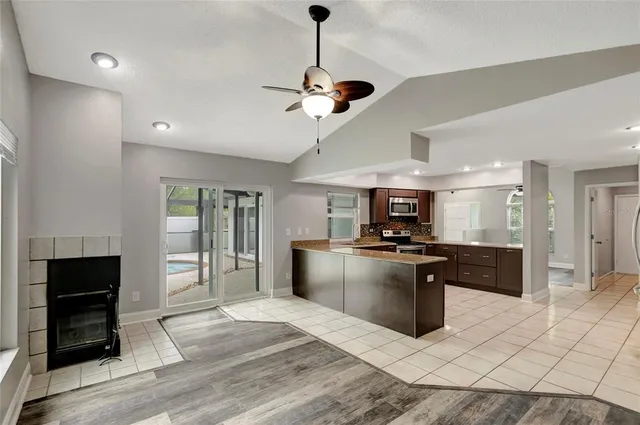 a kitchen with stainless steel appliances granite countertop a sink and a stove top oven