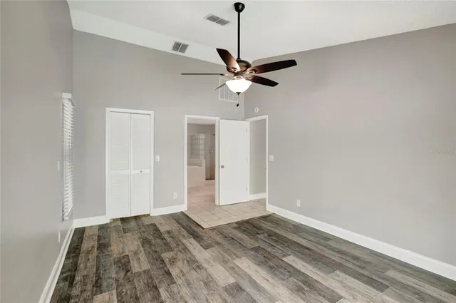 a view of a livingroom with a ceiling fan and hardwood floor
