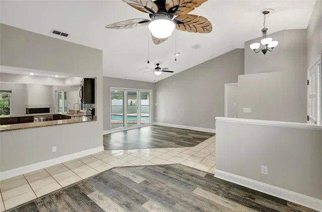 a view of kitchen and kitchen with a chandelier