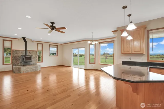 a kitchen with stainless steel appliances granite countertop a refrigerator a sink and a stove