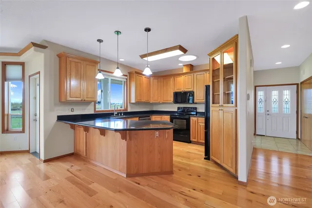 a kitchen with granite countertop cabinets stainless steel appliances and a window