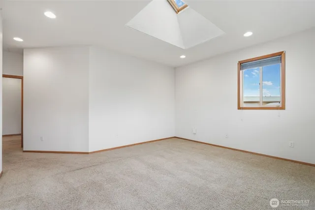 a spacious bathroom with a granite countertop sink and a mirror