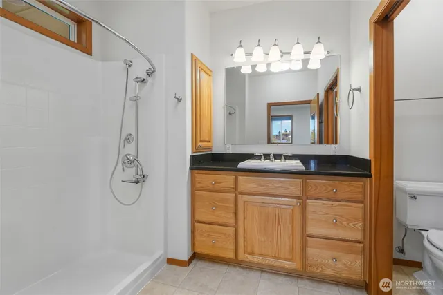 a bathroom with a sink toilet and shower