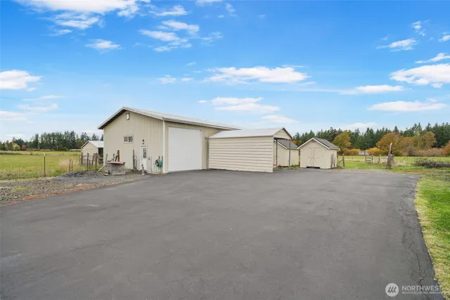 a view of a house with a yard and lake view
