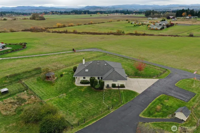 an aerial view of a golf course with a lake view