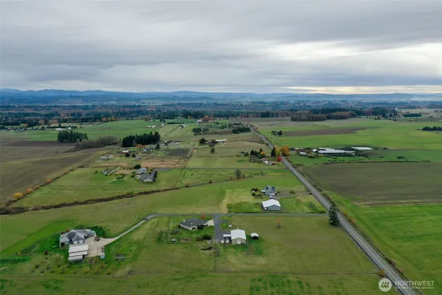 a backyard of a house with lots of green space and garden