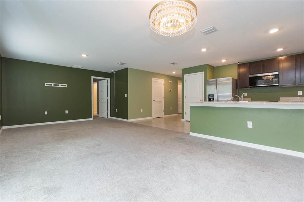 5358 Woodridge Lane Spring Hill, FL 34609 - Photo 11 of 32 a view of a kitchen with a sink and a microwave