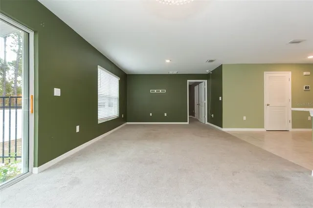 an empty room with windows and entrance