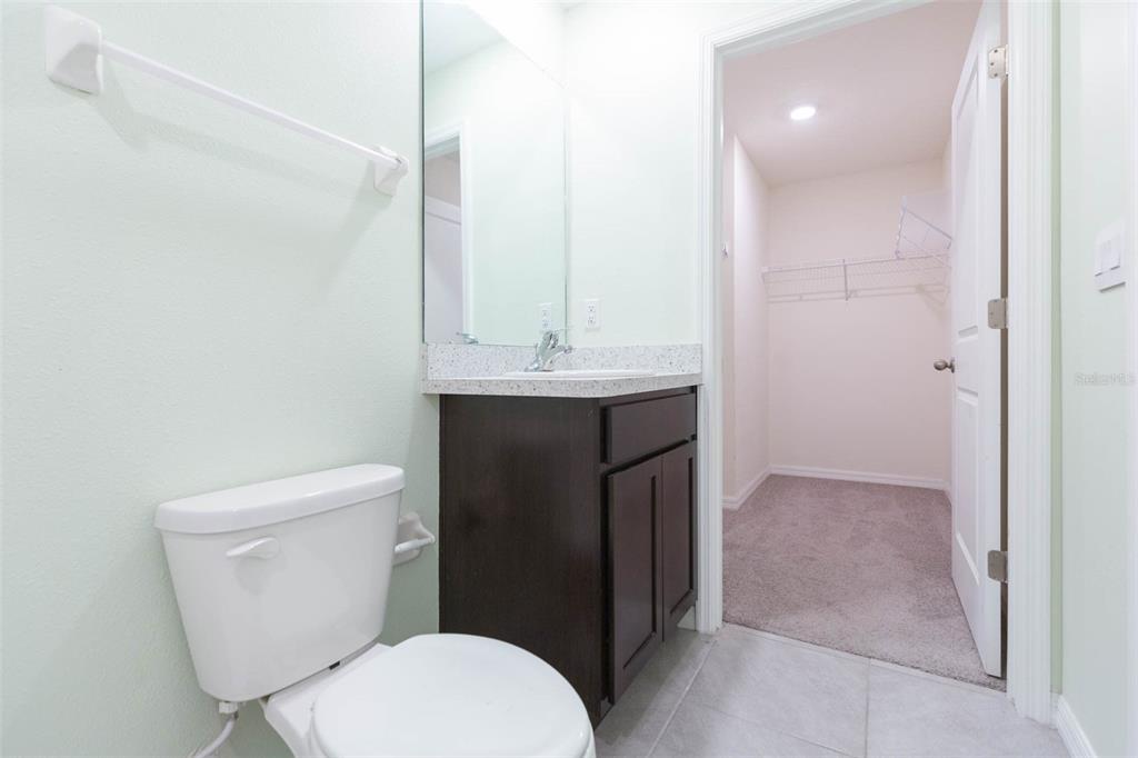 5358 Woodridge Lane Spring Hill, FL 34609 - Photo 18 of 32 a bathroom with a toilet a sink and mirror