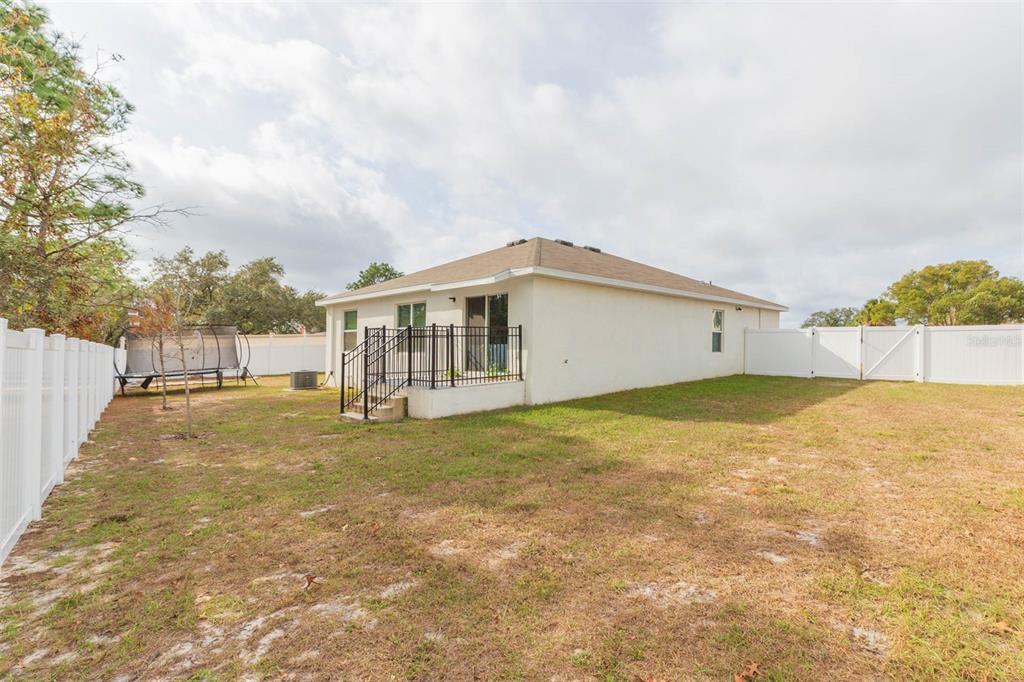 5358 Woodridge Lane Spring Hill, FL 34609 - Photo 30 of 32 a view of a house with backyard and garden