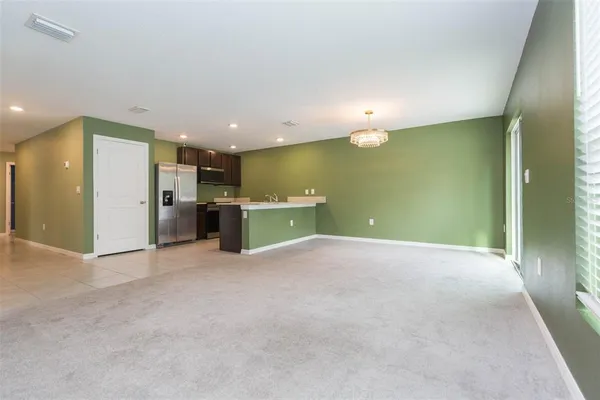 an empty room with a kitchen