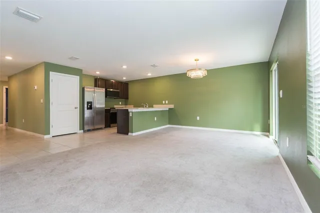 an empty room with a kitchen