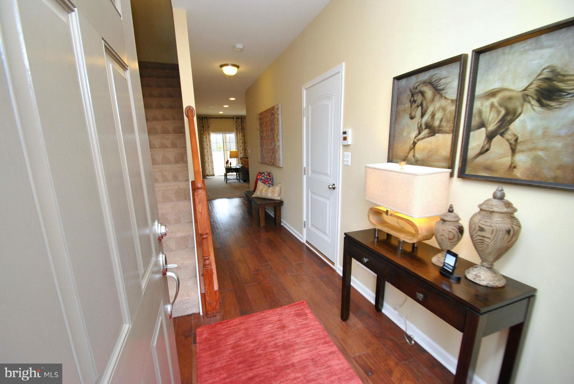 909 Ramble Run Road Baltimore, MD 21220 - Photo 3 of 21 a living room with furniture and wooden floor
